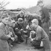 Żołnierze Kompanii Lotniczej Grupy Kampinos słuchają audycji Błyskawicy, we wsi Wiersze, około 15 września 1944 roku. Źródło: Wikipedia